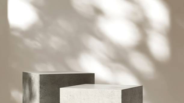 istock Two modern concrete cement gray cuboid table podium in sunlight on white wall room 2151532364