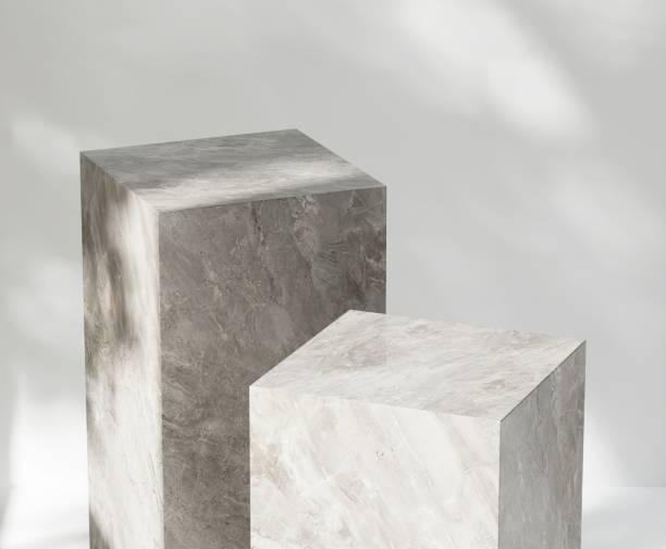 istock Two modern marble gray cuboid table podium in sunlight on white wall room 2151532371
