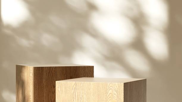 istock Two modern wooden gray cuboid table podium in sunlight on white wall room 2151532395