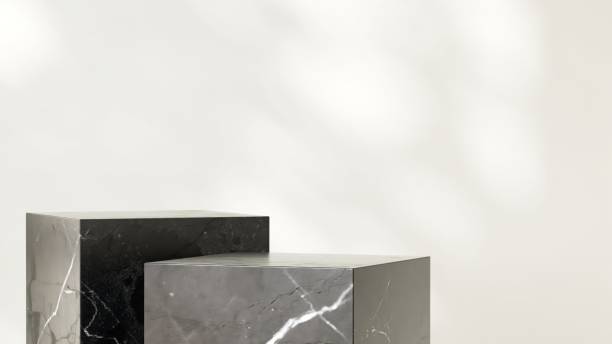 istock Two modern marble black cuboid table podium in sunlight on white wall room 2151532425