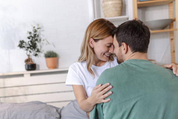 istock Beautiful couple embracing in bed 2151533323