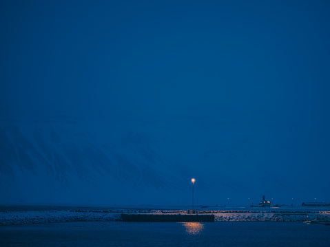 Pier in front of Kirkjufell during blue hour snowing winter time