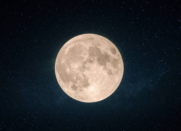 istock Beautiful yellow full moon with craters in the starry sky. 2151535977