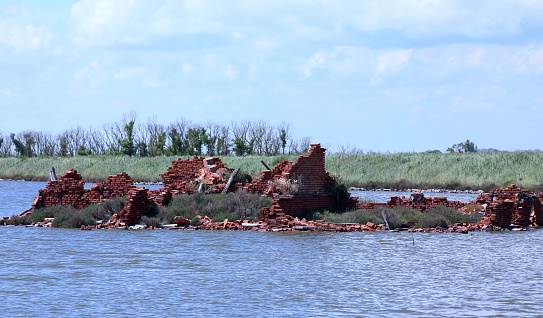 Flood-ravaged ruins of an old abandoned red brick house