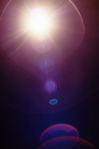 Real lens flare with organic imperfections on dark background