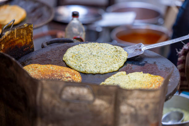 istock cooking Indian dough dishes in a frying pan 2151536953