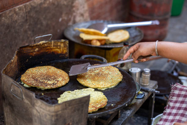 istock cooking Indian dough dishes in a frying pan 2151536973