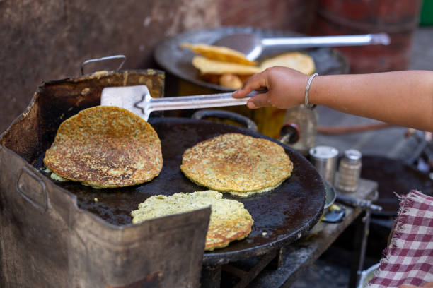 cooking Indian dough-based dishes in a frying pan