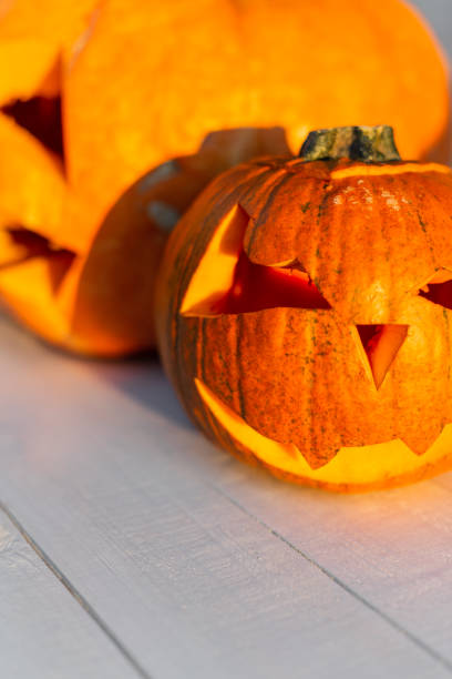 istock Brightly colored vampire pumpkin on a white wooden table. Happy Halloween 2151537540
