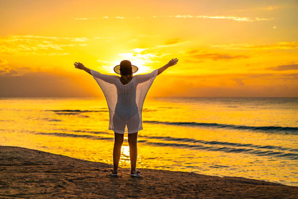 istock Beach holiday - beautiful woman walking on beach 2151538465
