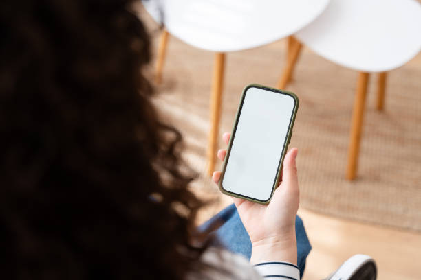 istock Woman holding smartphone with blank screen 2151539294