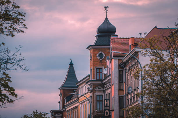 dramatic sunset over tenement houses in the city, illuminated city at night, old urban architecture