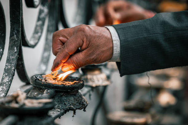 Burning incense in temples is a common practice in many cultures, Lighting candles in temples symbolizes devotion and spiritual reverence, Prayer rolls are played while walking around the stupa in a clockwise direction