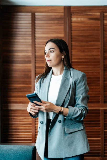 istock woman in the office using her smartphone 2151540510