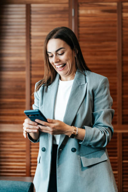 istock woman in the office using her smartphone 2151540521