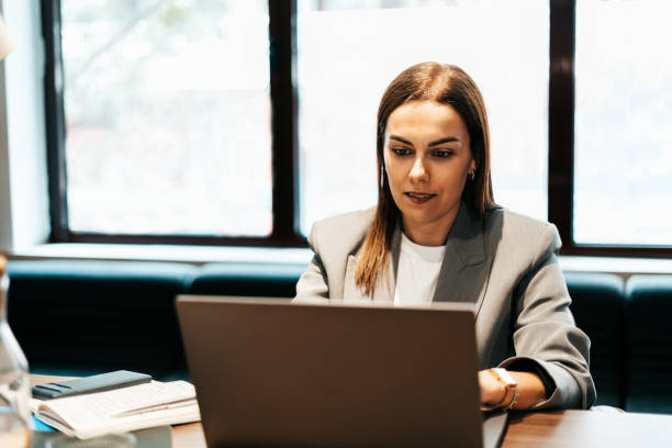 istock woman working in an office typing on the laptop 2151540598