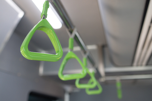 The green handles on the train are bright and eye-catching. They are designed to be easily visible and to provide a sense of safety and security for passengers
