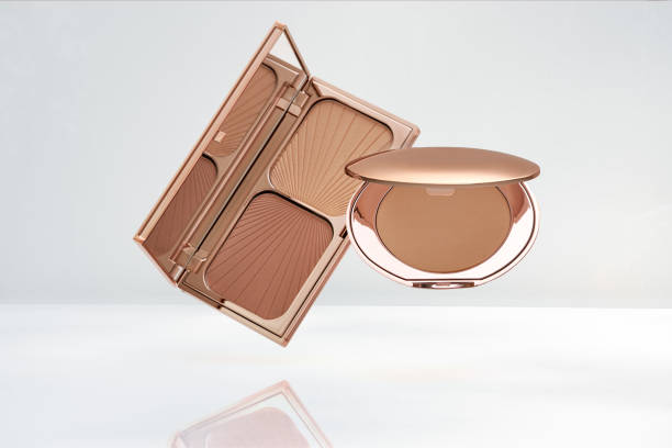 Compact make-up powder and Face contouring palette levitation on white background