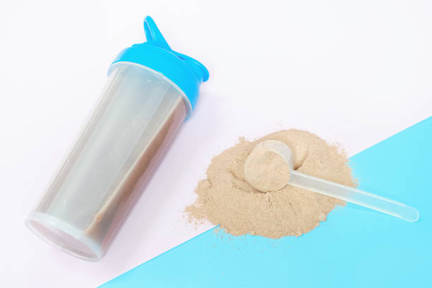istock Scoop with protein powder on blue and pink background top view. 2151545093