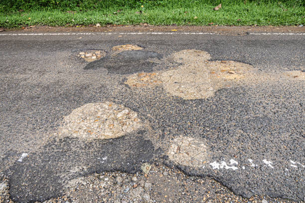 istock Pot hole in a asphalt road 2151545541