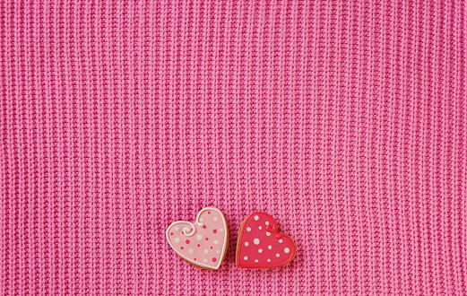 Two Decorative Heart-Shaped Cookies on a Pink Textured Background for Valentines Day