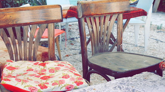 Two Old Wooden Chairs and a Pillow. Outdoor