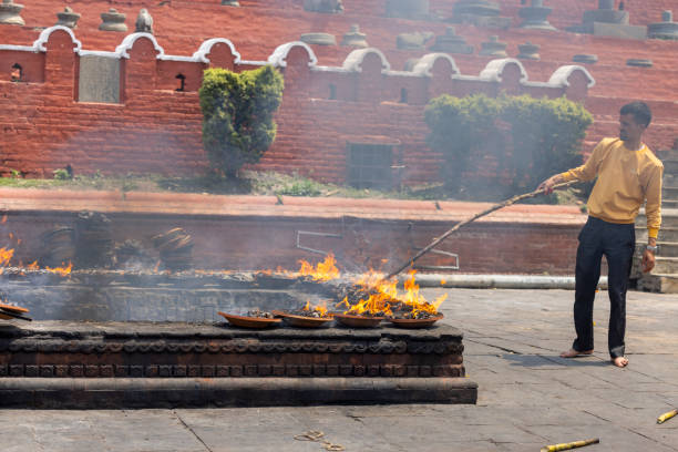 Kathmandu, Nepal-April 22,2024: people making the fire ceremony inside the Pashupatinath temple in the morning