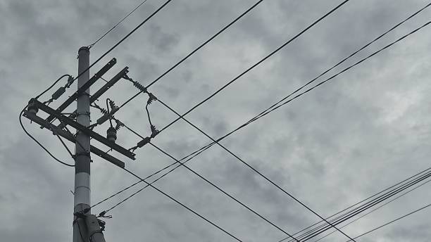 istock Electricity pole with cloudy sky as the background in industrial area 2151554196
