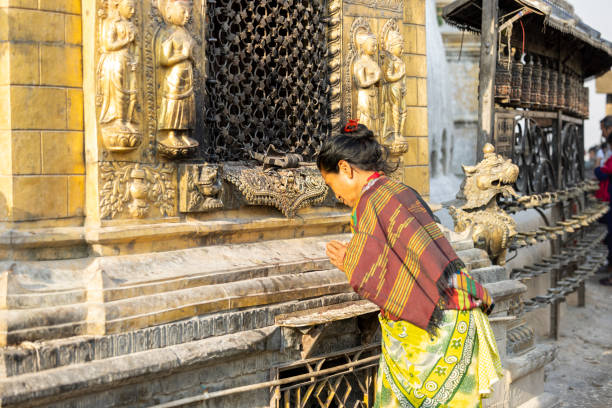 Kathmandu, Nepal-April 22,2024: Burning incense in temples is a common practice in many cultures, Lighting candles in temples symbolizes devotion and spiritual reverence, Prayer rolls are played while walking around the stupa in a clockwise direction