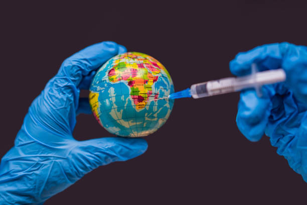 istock Syringe vaccinates the globe, on a map of the USA. USA Coronavirus, Corona virus attack concept. America fight against coronavirus. Concept of fight against coronavirus, danger and public health risk disease. Global Covid19 Vaccination Strategy concept. 2151557504