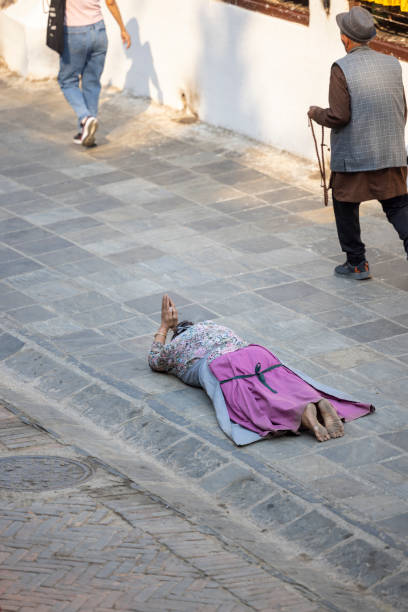 Kathmandu, Nepal-April 23,2024: Buddhists, and visitors typically come here to meditate, pray, and chant mantras while circumambulating the stupa