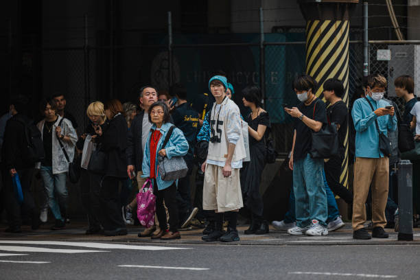 Tokyo, Japan-April 27,2024: In Tokyo, pedestrians obey traffic rules at red lights and wait for the green light to cross.