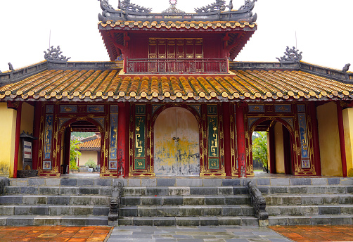Hue, Vietnam - October 8, 2022: Antique wood architecture of the entrance to Minh Mang Mausoleum