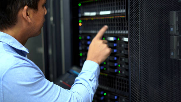 istock An IT professional in a blue shirt manages and monitors network servers in a data center, ensuring system stability and security. 2151569600