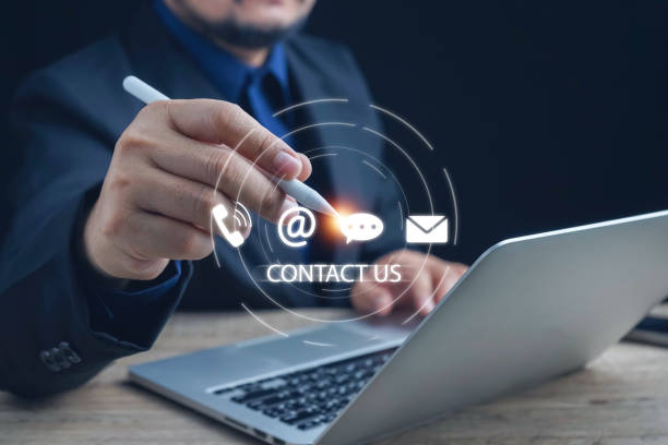 istock Contact us or Customer support hotline, people connect. Businessman touching on virtual screen contact icons (email, address, live chat, telephone). Customer service, helpdesk advice online support. 2151569823