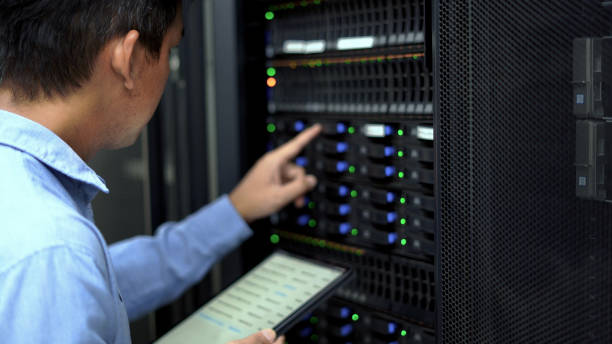istock An IT professional in a blue shirt manages and monitors network servers in a data center, ensuring system stability and security. 2151569869