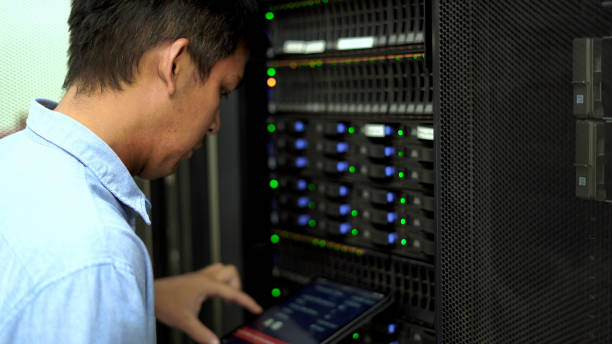 istock An IT professional in a blue shirt manages and monitors network servers in a data center, ensuring system stability and security. 2151569870
