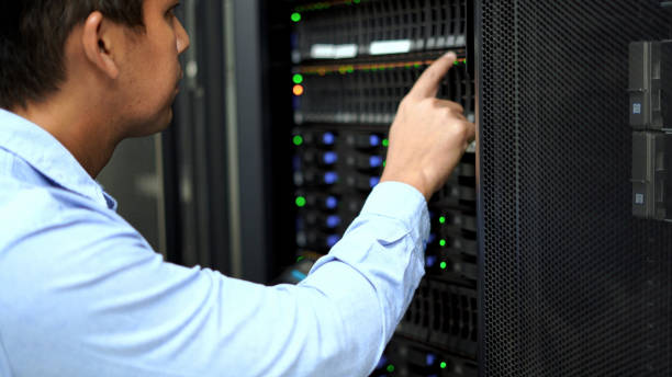 istock An IT professional in a blue shirt manages and monitors network servers in a data center, ensuring system stability and security. 2151569872