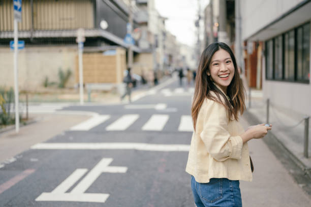 istock Modern life genZ using navigation technology to find her way around city in Osaka Japan 2151571228