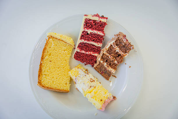 Assorted Cakes on a White Plate: Classic Pink Yellow Sponge Cake, Rich Red Velvet, and Decadent Black Forest