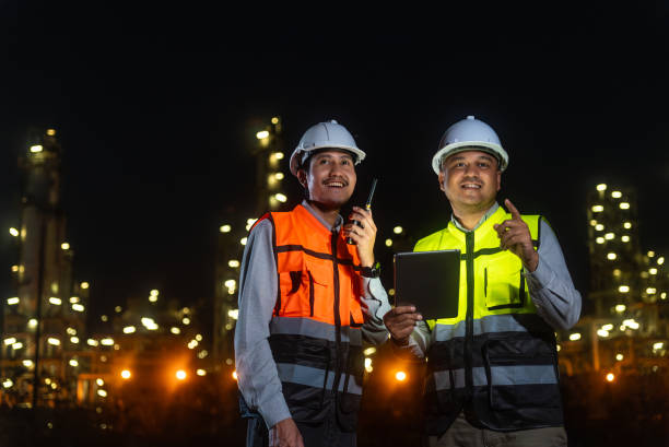 istock Happy handsome Asian man petrochemical engineers using digital tablet working and shaking hands together after going through routine checks at petroleum oil refinery in industrial estate. 2151572528