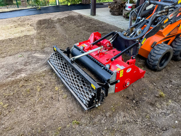 A municipal worker sows a lawn using a Boxer mechanical seeder. Planting a lawn. Nitra, Slovakia - 08.15.2023: A municipal worker sows a lawn using a Boxer mechanical seeder. Planting a lawn. lawn seeder stock pictures, royalty-free photos & images