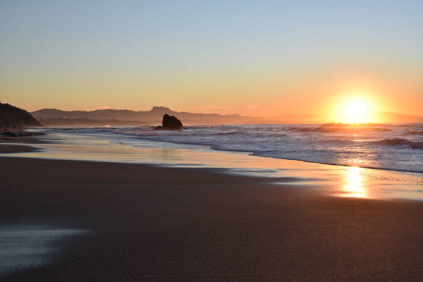 istock Sunset on a beach with a rock in Biarritz, France 2151576861