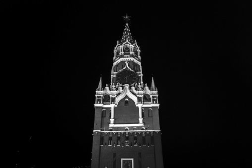 The black and white photo of the Kremlin Clock (Kremlin Chimes) on the historic the Spasskaya Tower of Moscow Kremlin, Russia.