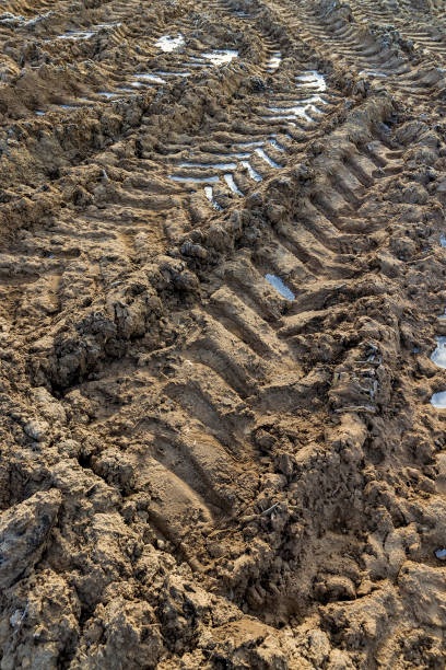 istock a deep track from a heavy car in a field 2151579463