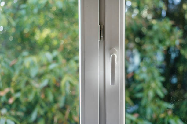 istock Close up window handle against blurred background with lush foliage and natural park 2151580439