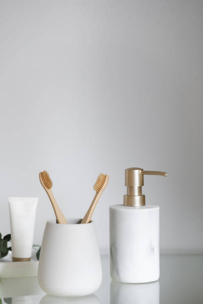 istock Bamboo toothbrush against toothpaste tube and soap dispenser bottle 2151580488
