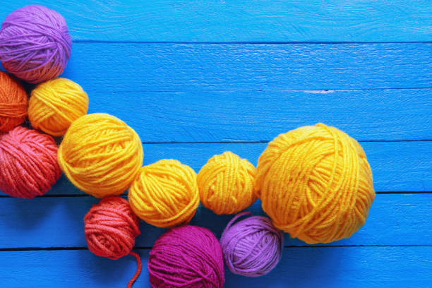 istock Hobby and knitting concept. Colorful balls of wool on blue rustic table. Copy space 2151583344