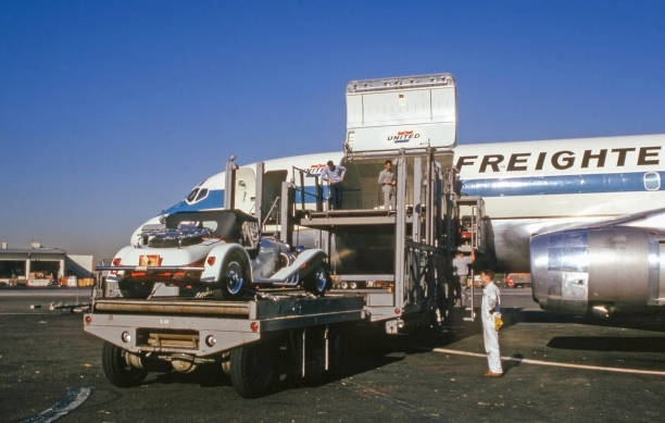 California, USA - November 1966: A 1966 Excalibur series 1 roadster being loaded onto a United Airlines DC-8F air freight jet airplane.