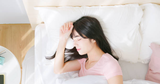 Top view closeup asian woman has good sleep quality in her room laying on bed
